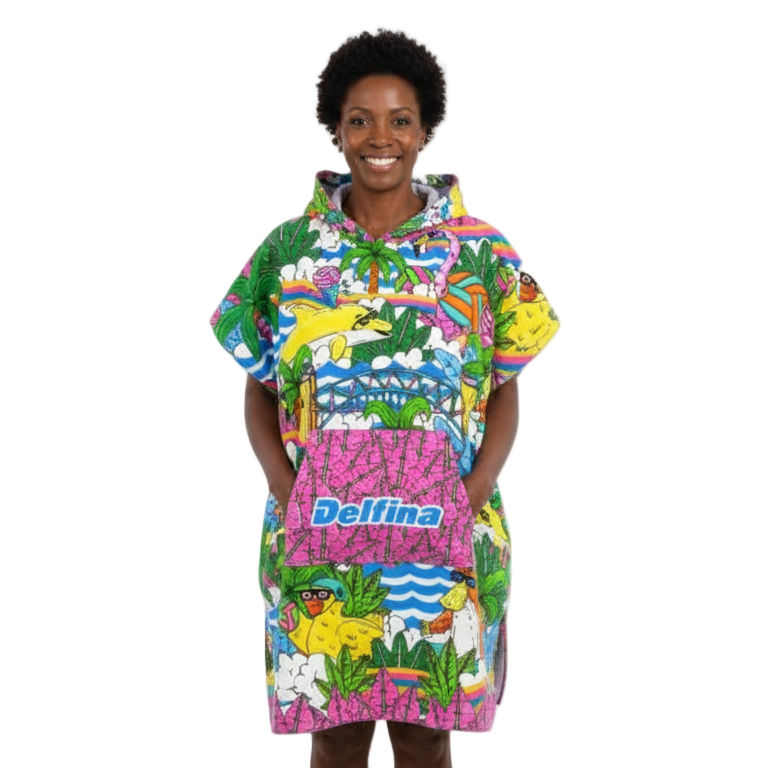 Person wearing a colorful floral patterned poncho with 'Delfina' branding on a white background